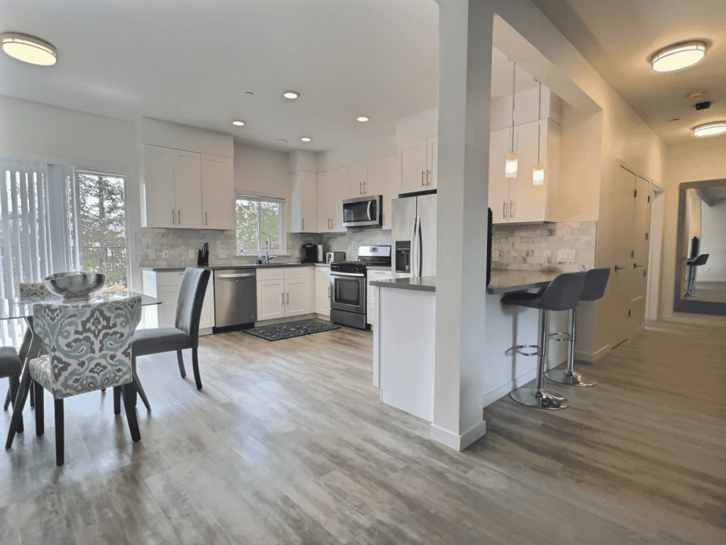 Fully-equipped kitchen with bar seating and olive orchard views.