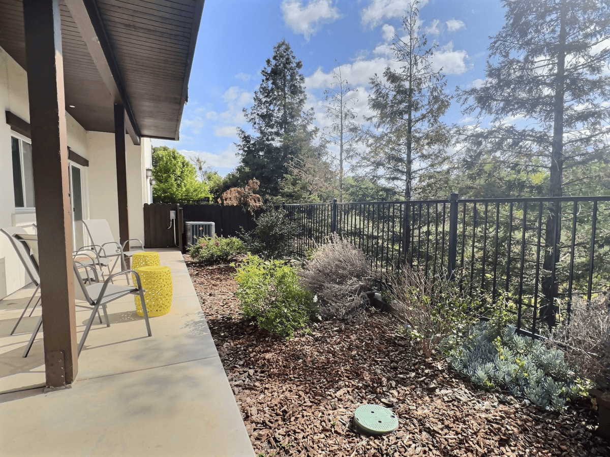 Patio view from master bedroom with chairs and olive orchard views.