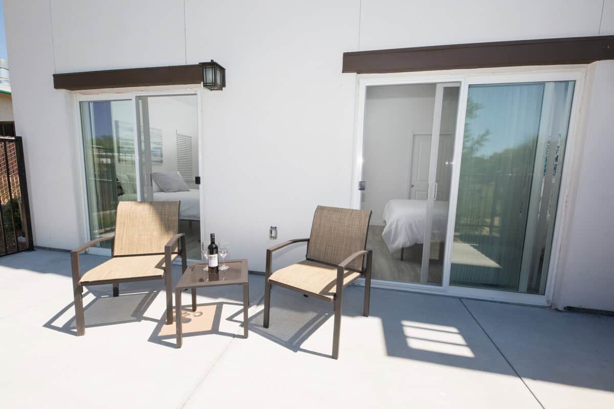 Bedroom 1 features a queen bed and serene olive orchard views, with a chance to spot wild turkeys.