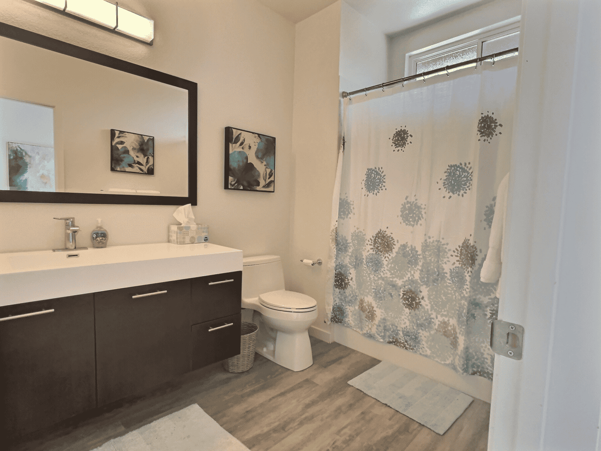 Private master bath with large vanity and shower, stocked with essentials for a spa-like retreat.