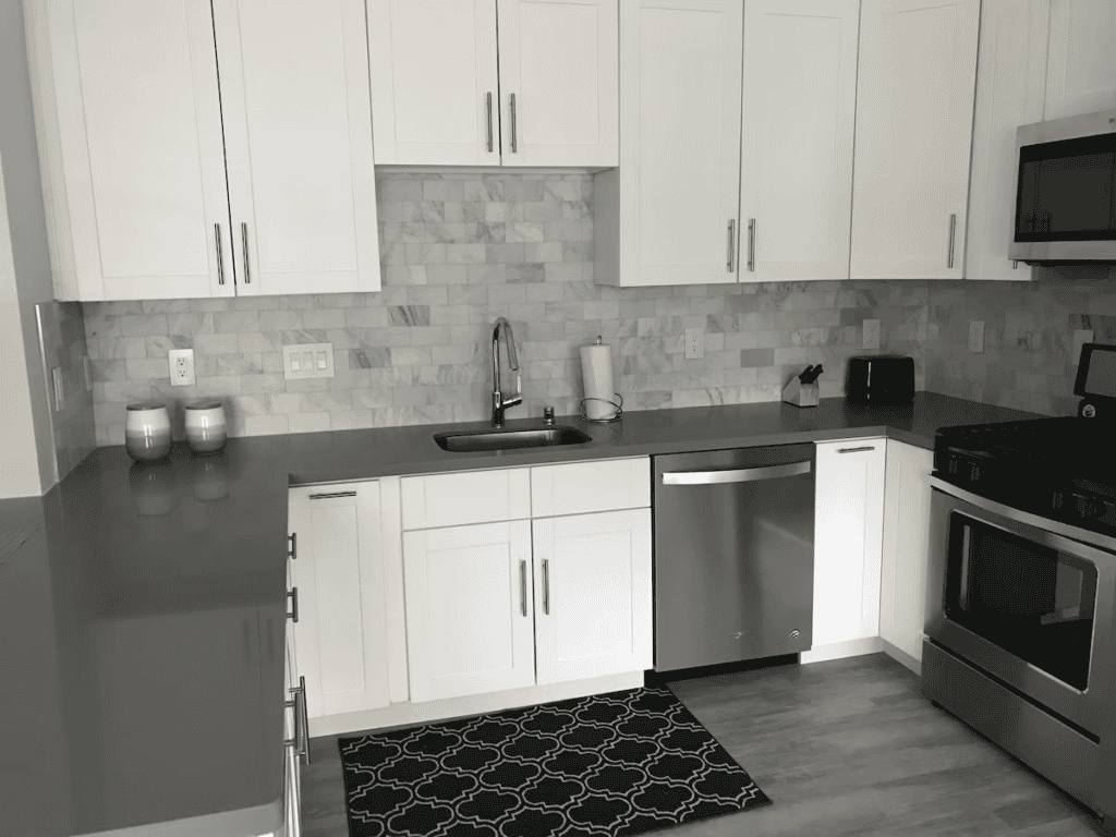 Fully-stocked kitchen with gas stove, microwave, dishwasher, and Keurig.